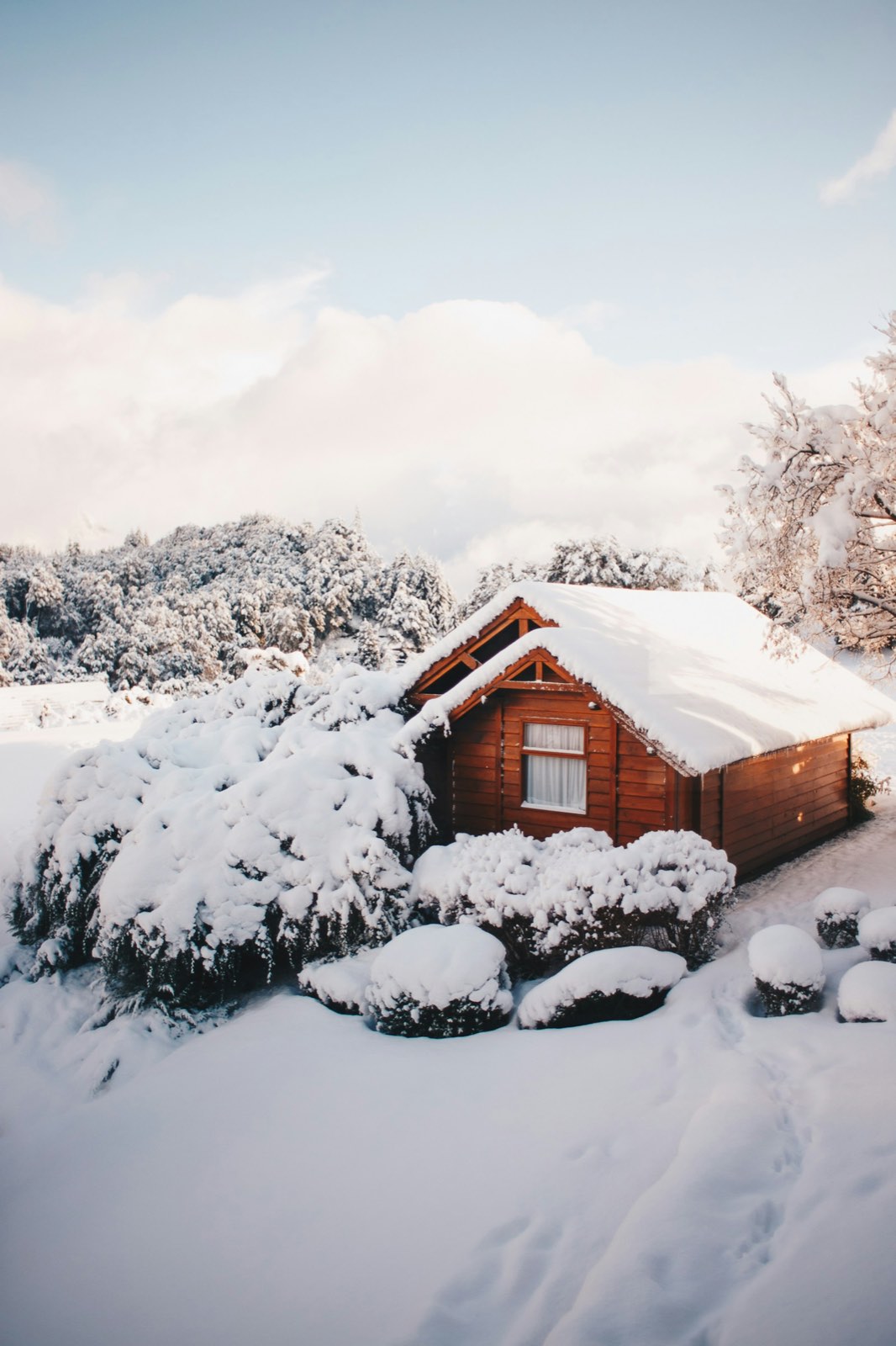 Wooden cabin buried in deep fresh snow